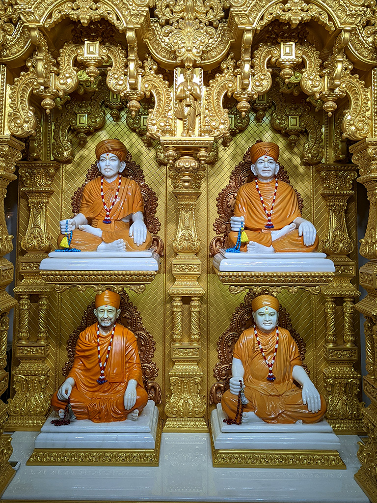 Top Left, Brahmaswarup Shastriji Maharaj, Top Right Brahmaswarup Yogiji Maharaj, Bottom Left Brahmaswarup Hariprasad Swamiji and Bottom Right Brahmaswarup Aksharvihari Swamiji