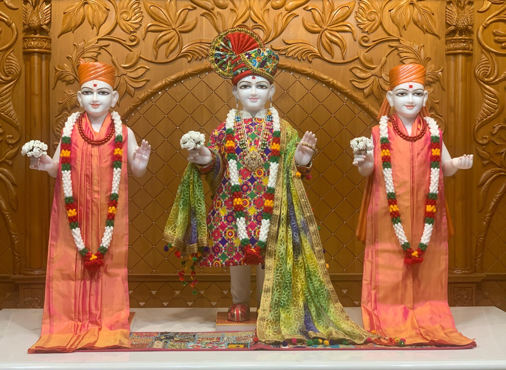 In Centre, Poorna Purushottam Shree Sahajanand Swami Maharaj, On Left Anadi Mul Akshar Murti Shree Gunatitanand Swami and On Right Anadi Mahamukta Shree Gopalanand Swami