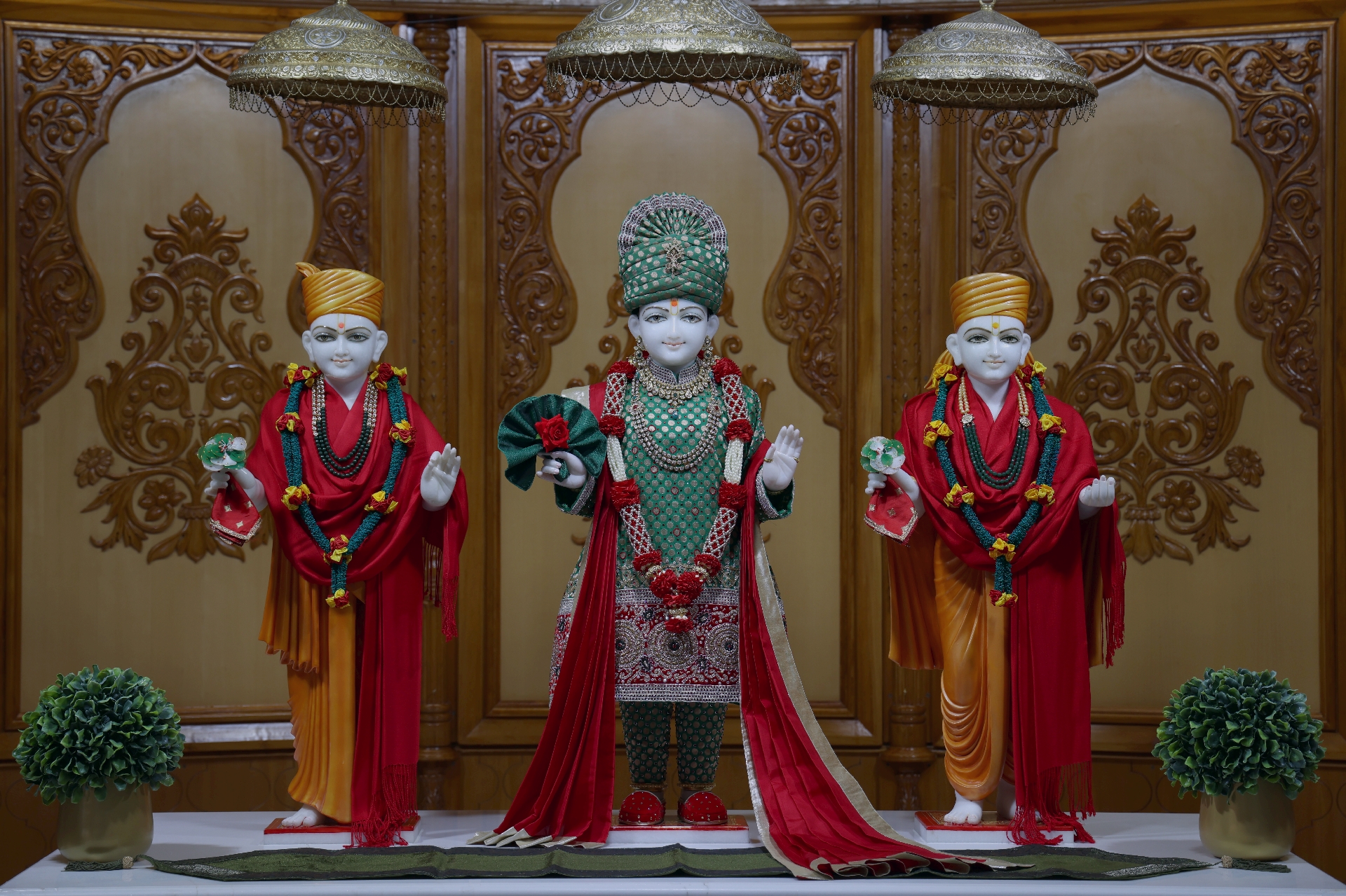 In Centre, Poorna Purushottam Shree Sahajanand Swami Maharaj, On Left Anadi Mul Akshar Murti Shree Gunatitanand Swami and On Right Anadi Mahamukta Shree Gopalanand Swami