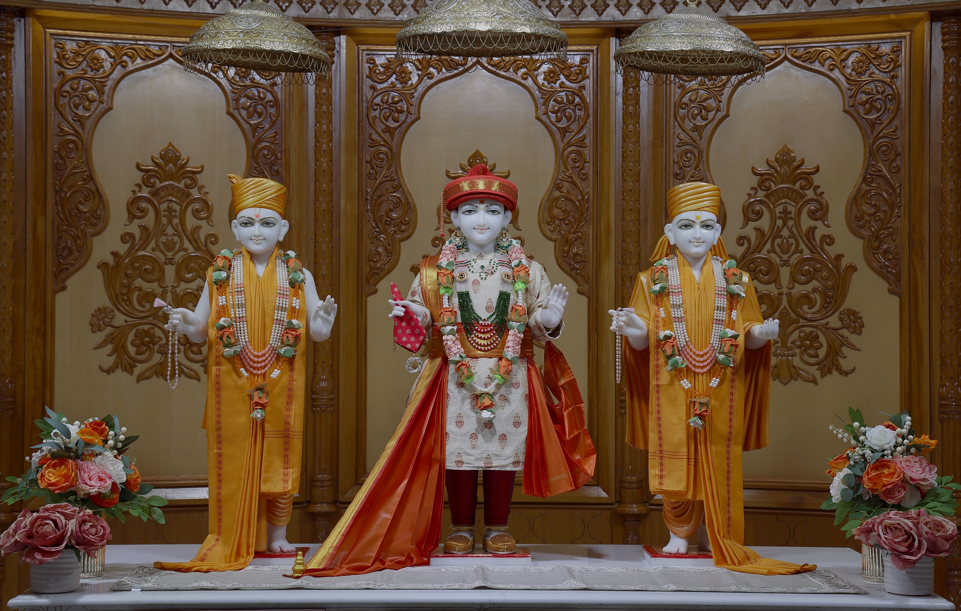 In Centre, Poorna Purushottam Shree Sahajanand Swami Maharaj, On Left Anadi Mul Akshar Murti Shree Gunatitanand Swami and On Right Anadi Mahamukta Shree Gopalanand Swami