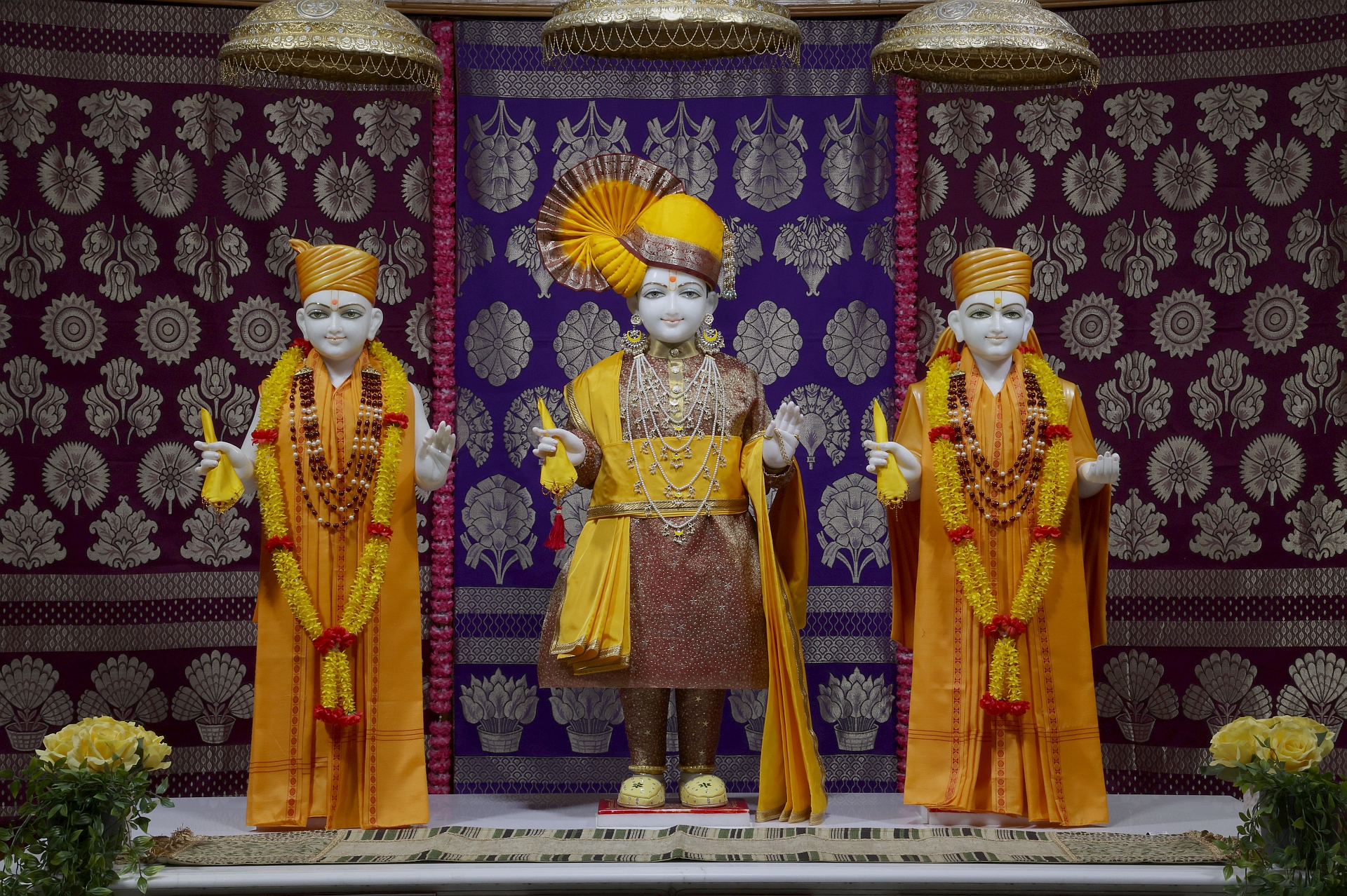 In Centre, Poorna Purushottam Shree Sahajanand Swami Maharaj, On Left Anadi Mul Akshar Murti Shree Gunatitanand Swami and On Right Anadi Mahamukta Shree Gopalanand Swami