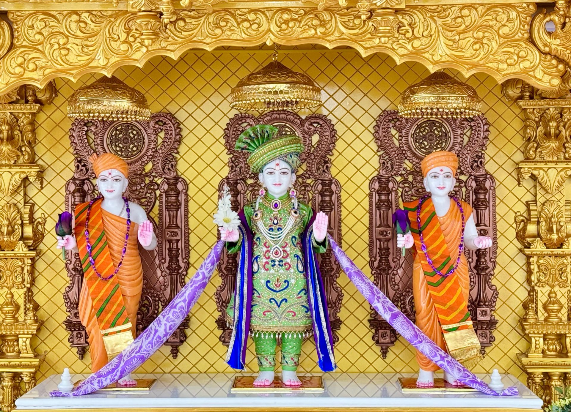 In Centre, Poorna Purushottam Shree Sahajanand Swami Maharaj, On Left Anadi Mul Akshar Murti Shree Gunatitanand Swami and On Right Anadi Mahamukta Shree Gopalanand Swami