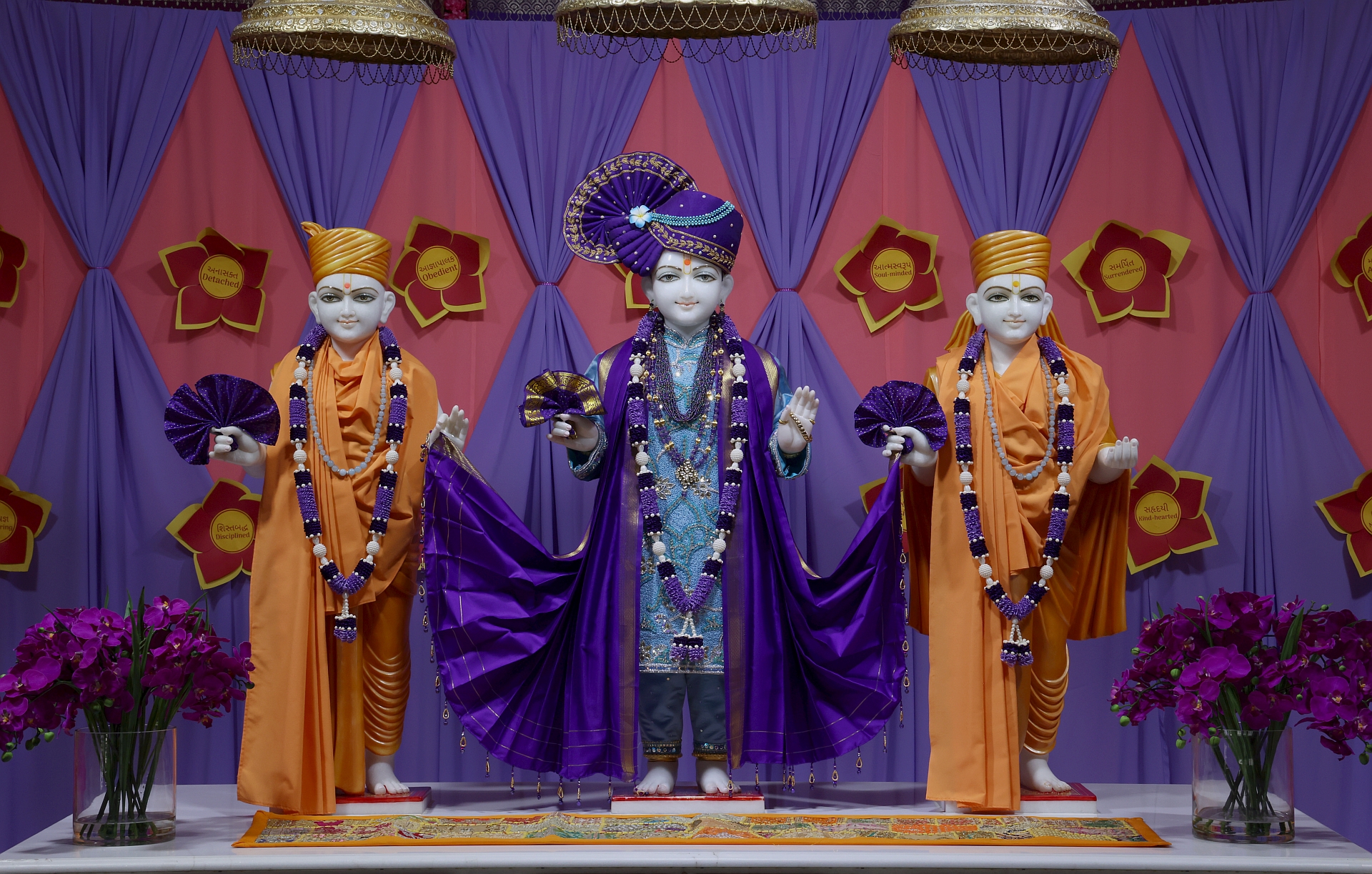 In Centre, Poorna Purushottam Shree Sahajanand Swami Maharaj, On Left Anadi Mul Akshar Murti Shree Gunatitanand Swami and On Right Anadi Mahamukta Shree Gopalanand Swami