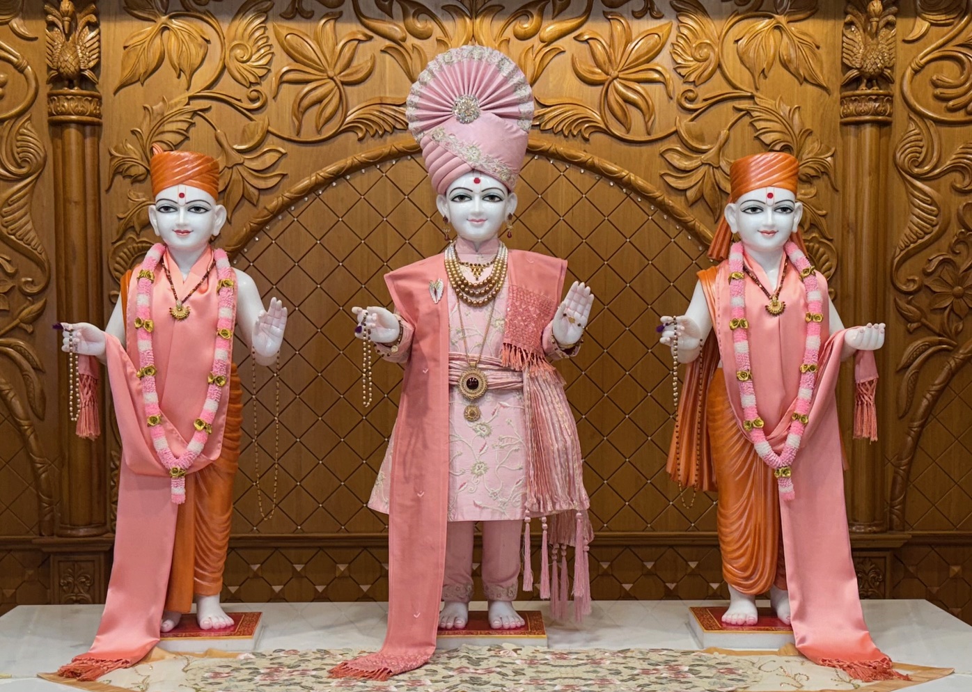 In Centre, Poorna Purushottam Shree Sahajanand Swami Maharaj, On Left Anadi Mul Akshar Murti Shree Gunatitanand Swami and On Right Anadi Mahamukta Shree Gopalanand Swami