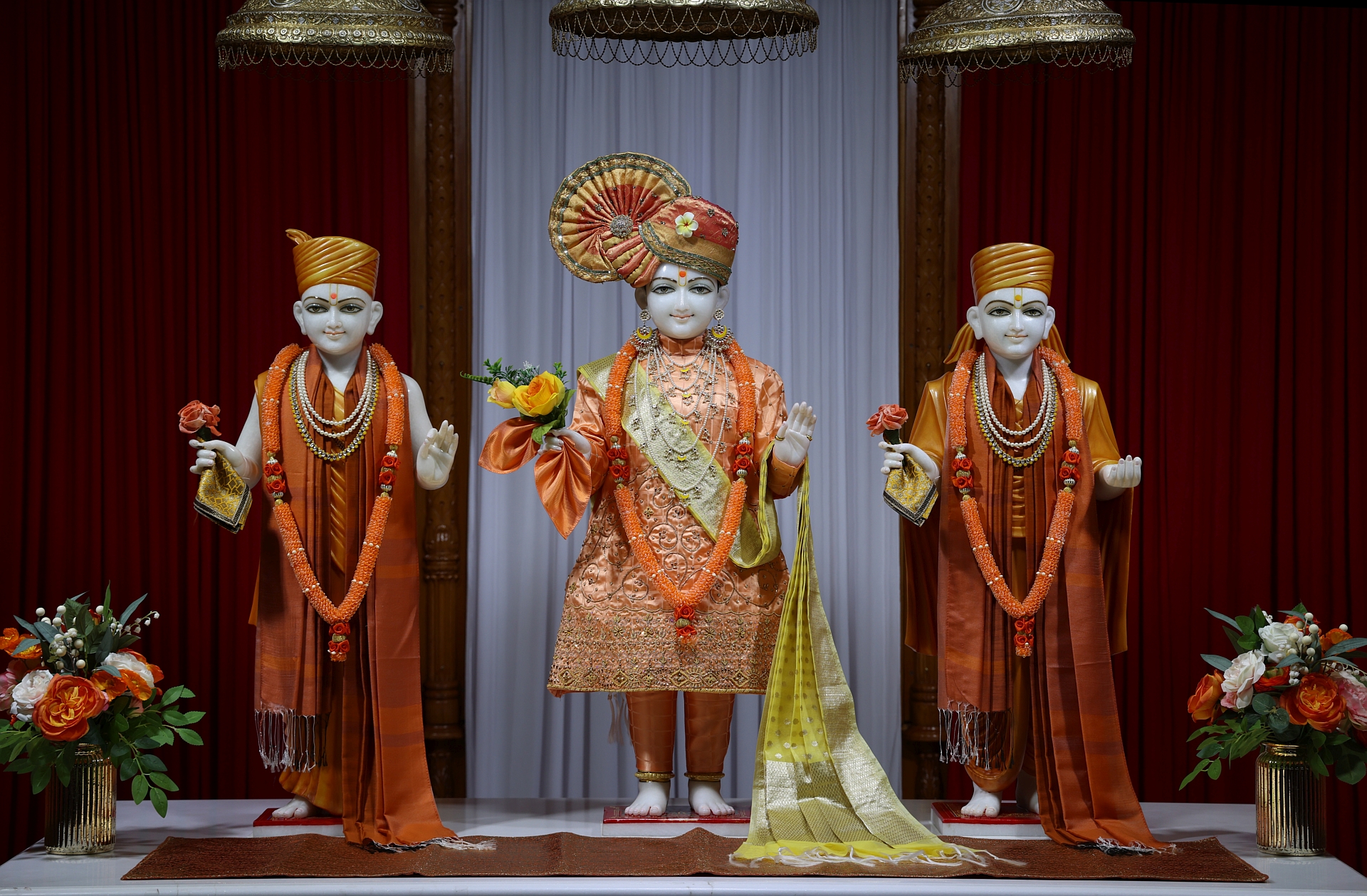 In Centre, Poorna Purushottam Shree Sahajanand Swami Maharaj, On Left Anadi Mul Akshar Murti Shree Gunatitanand Swami and On Right Anadi Mahamukta Shree Gopalanand Swami