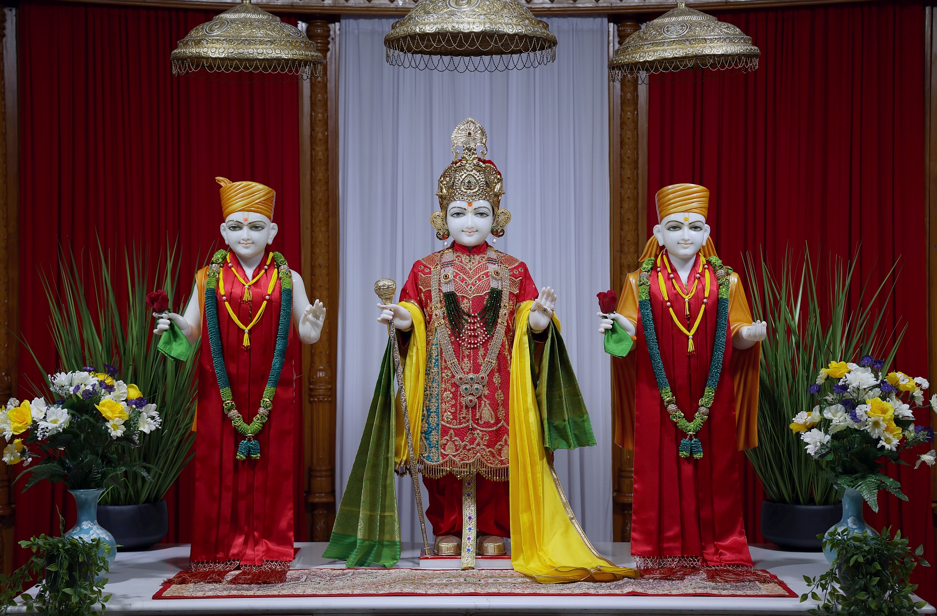 In Centre, Poorna Purushottam Shree Sahajanand Swami Maharaj, On Left Anadi Mul Akshar Murti Shree Gunatitanand Swami and On Right Anadi Mahamukta Shree Gopalanand Swami