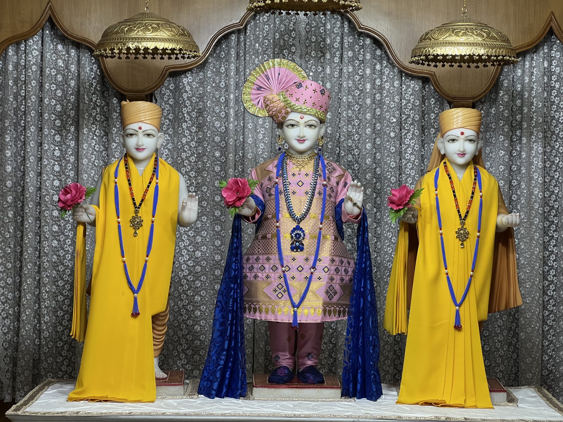 In Centre, Poorna Purushottam Shree Sahajanand Swami Maharaj, On Left Anadi Mul Akshar Murti Shree Gunatitanand Swami and On Right Anadi Mahamukta Shree Gopalanand Swami