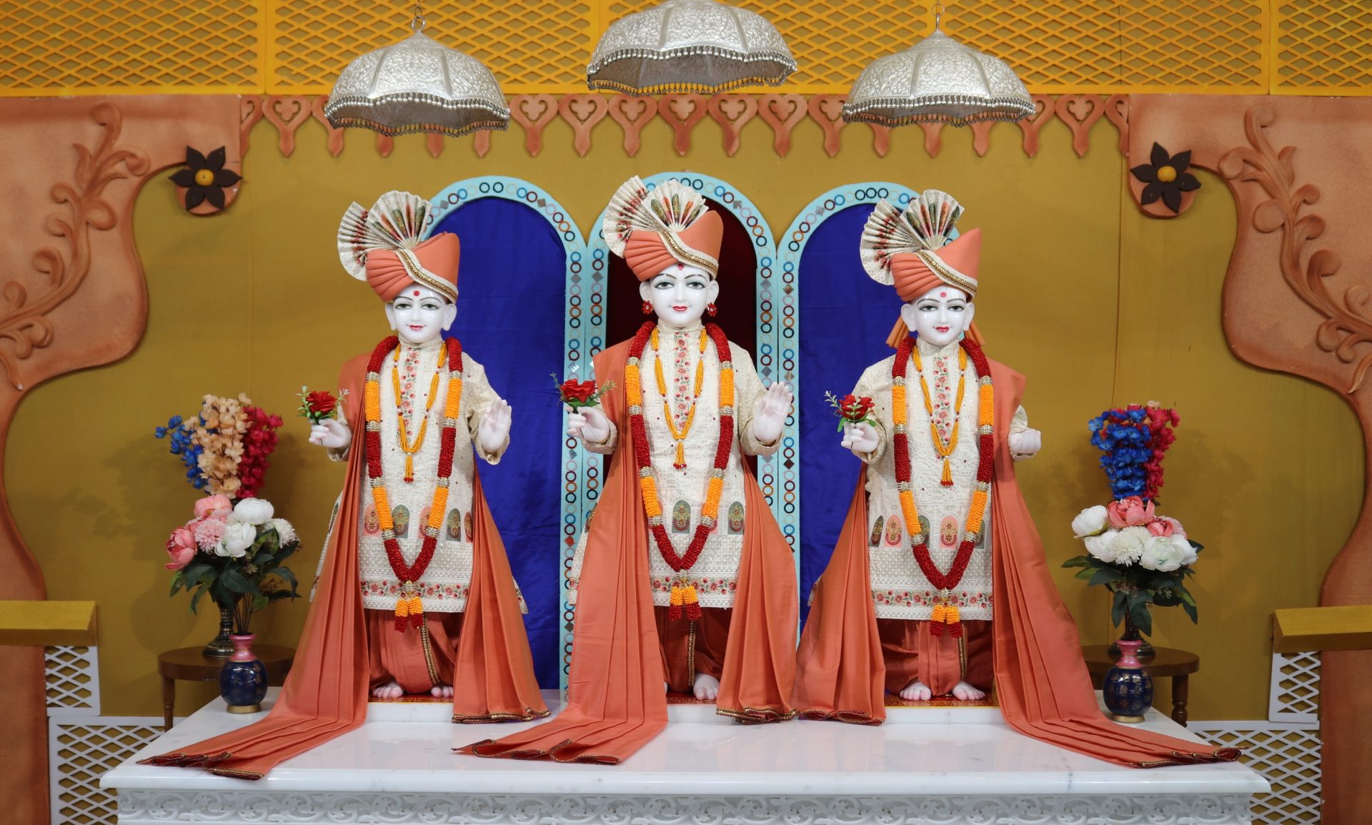 In Centre, Poorna Purushottam Shree Sahajanand Swami Maharaj, On Left Anadi Mul Akshar Murti Shree Gunatitanand Swami and On Right Anadi Mahamukta Shree Gopalanand Swami