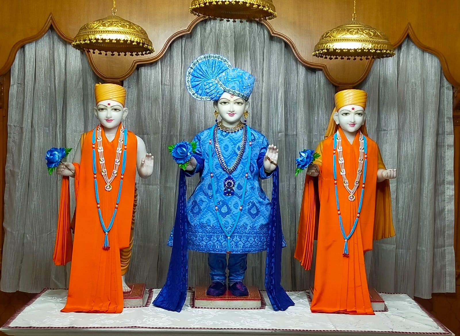 In Centre, Poorna Purushottam Shree Sahajanand Swami Maharaj, On Left Anadi Mul Akshar Murti Shree Gunatitanand Swami and On Right Anadi Mahamukta Shree Gopalanand Swami