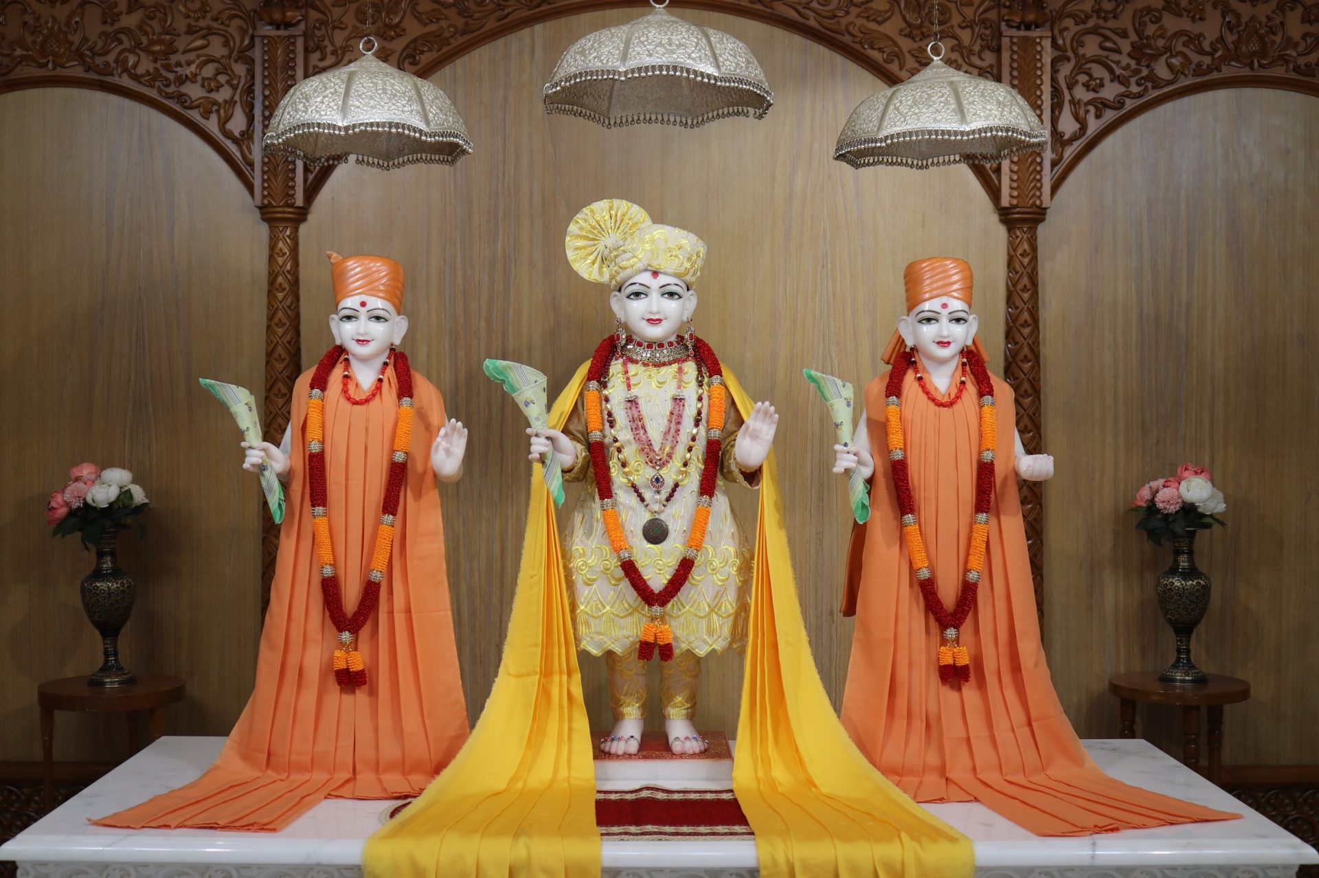 In Centre, Poorna Purushottam Shree Sahajanand Swami Maharaj, On Left Anadi Mul Akshar Murti Shree Gunatitanand Swami and On Right Anadi Mahamukta Shree Gopalanand Swami