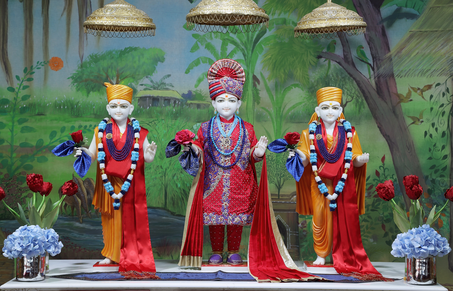 In Centre, Poorna Purushottam Shree Sahajanand Swami Maharaj, On Left Anadi Mul Akshar Murti Shree Gunatitanand Swami and On Right Anadi Mahamukta Shree Gopalanand Swami