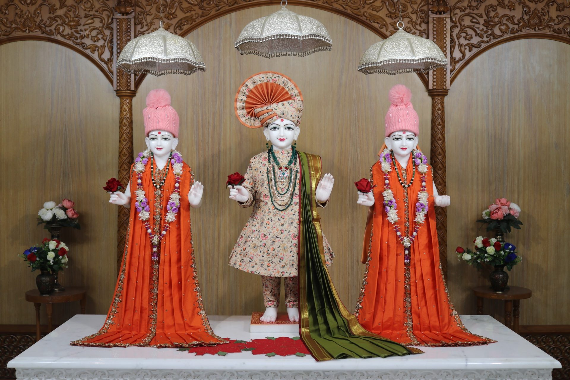 In Centre, Poorna Purushottam Shree Sahajanand Swami Maharaj, On Left Anadi Mul Akshar Murti Shree Gunatitanand Swami and On Right Anadi Mahamukta Shree Gopalanand Swami