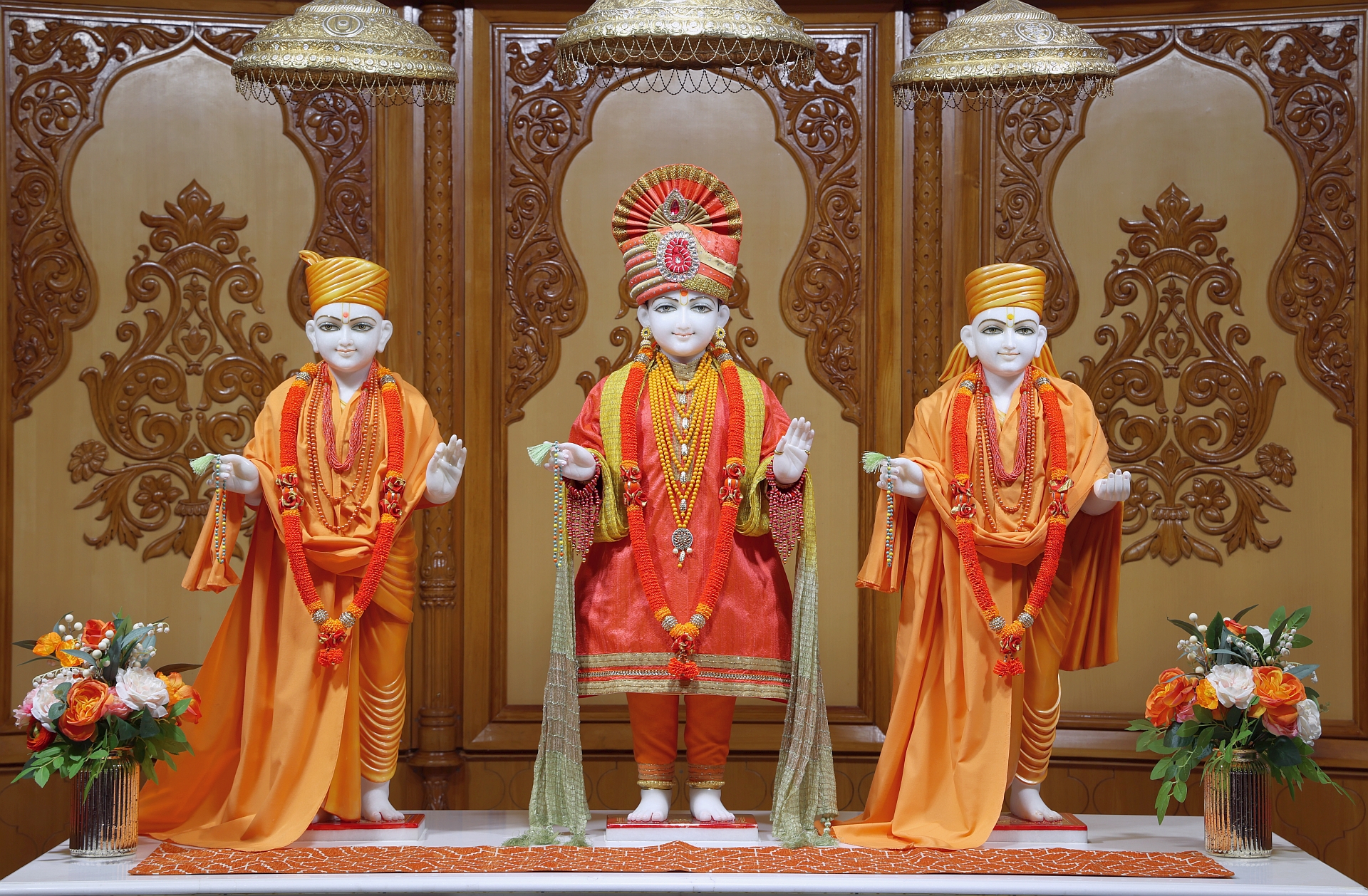 In Centre, Poorna Purushottam Shree Sahajanand Swami Maharaj, On Left Anadi Mul Akshar Murti Shree Gunatitanand Swami and On Right Anadi Mahamukta Shree Gopalanand Swami