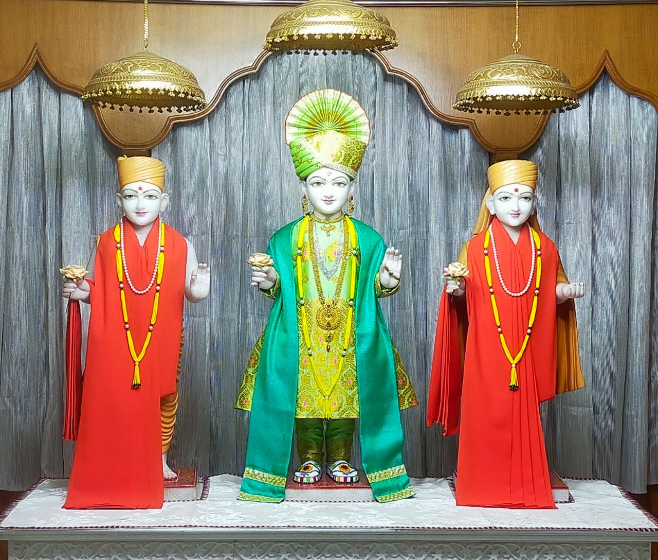 In Centre, Poorna Purushottam Shree Sahajanand Swami Maharaj, On Left Anadi Mul Akshar Murti Shree Gunatitanand Swami and On Right Anadi Mahamukta Shree Gopalanand Swami