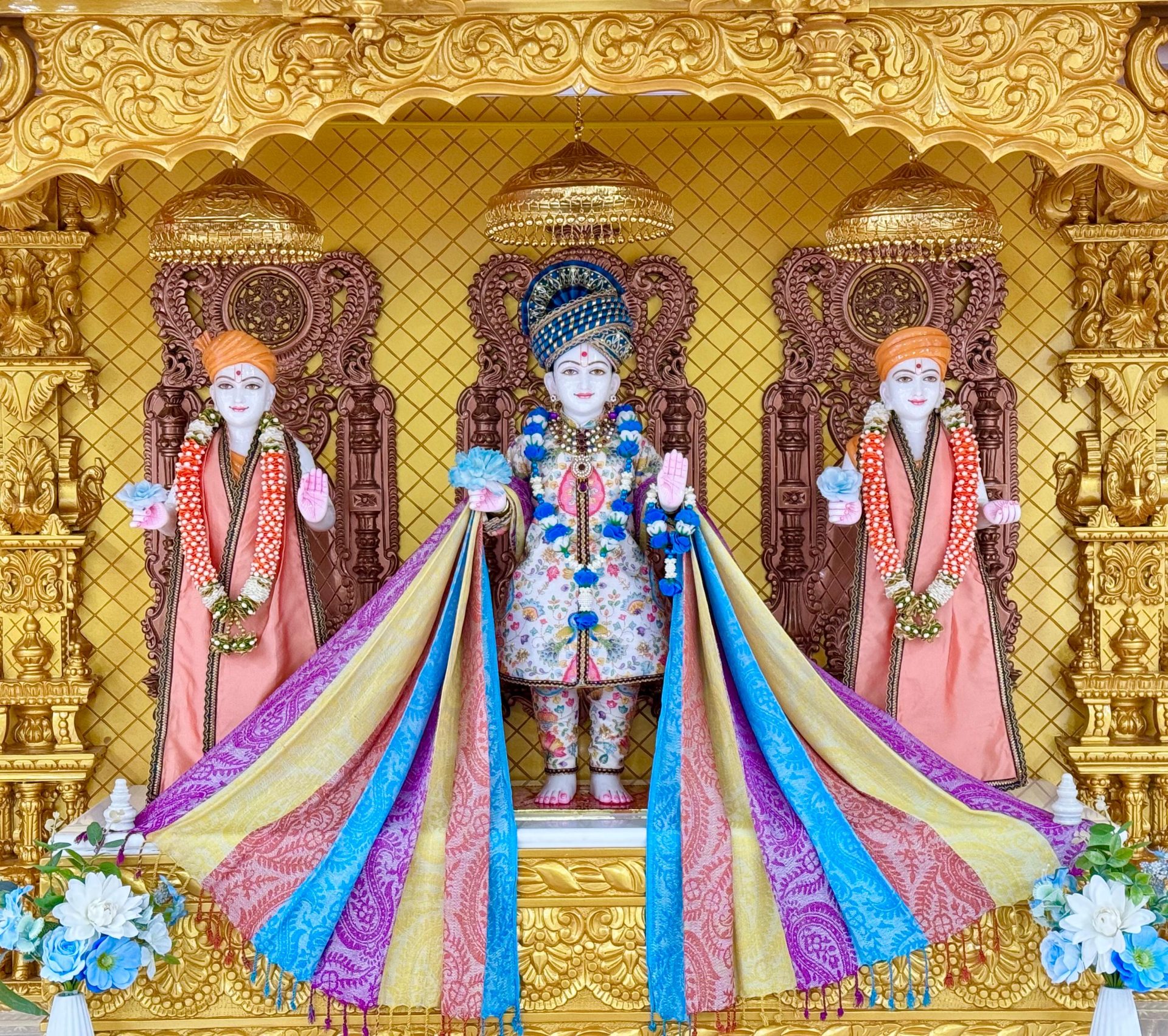 In Centre, Poorna Purushottam Shree Sahajanand Swami Maharaj, On Left Anadi Mul Akshar Murti Shree Gunatitanand Swami and On Right Anadi Mahamukta Shree Gopalanand Swami