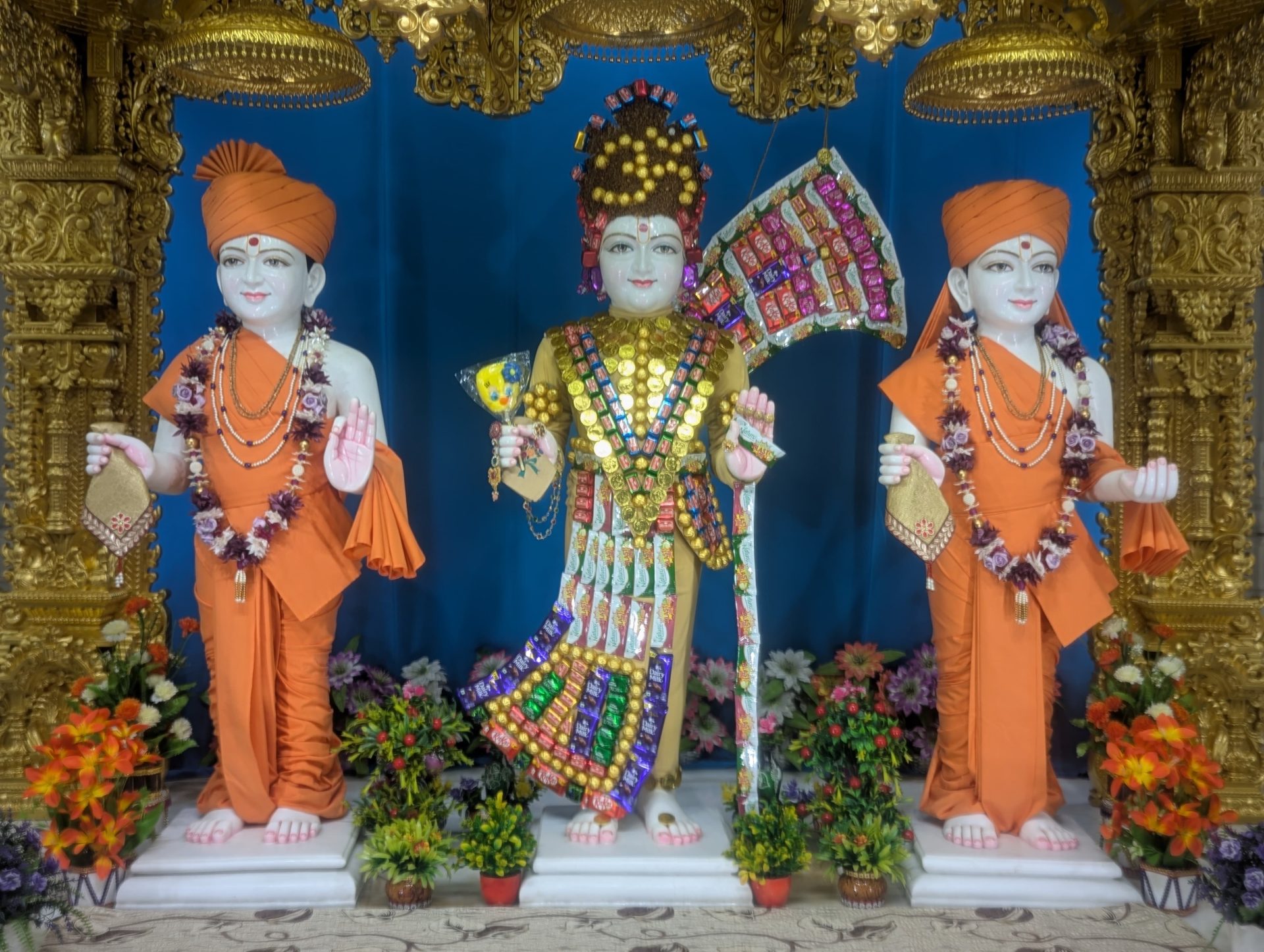 In Centre, Poorna Purushottam Shree Sahajanand Swami Maharaj, On Left Anadi Mul Akshar Murti Shree Gunatitanand Swami and On Right Anadi Mahamukta Shree Gopalanand Swami
