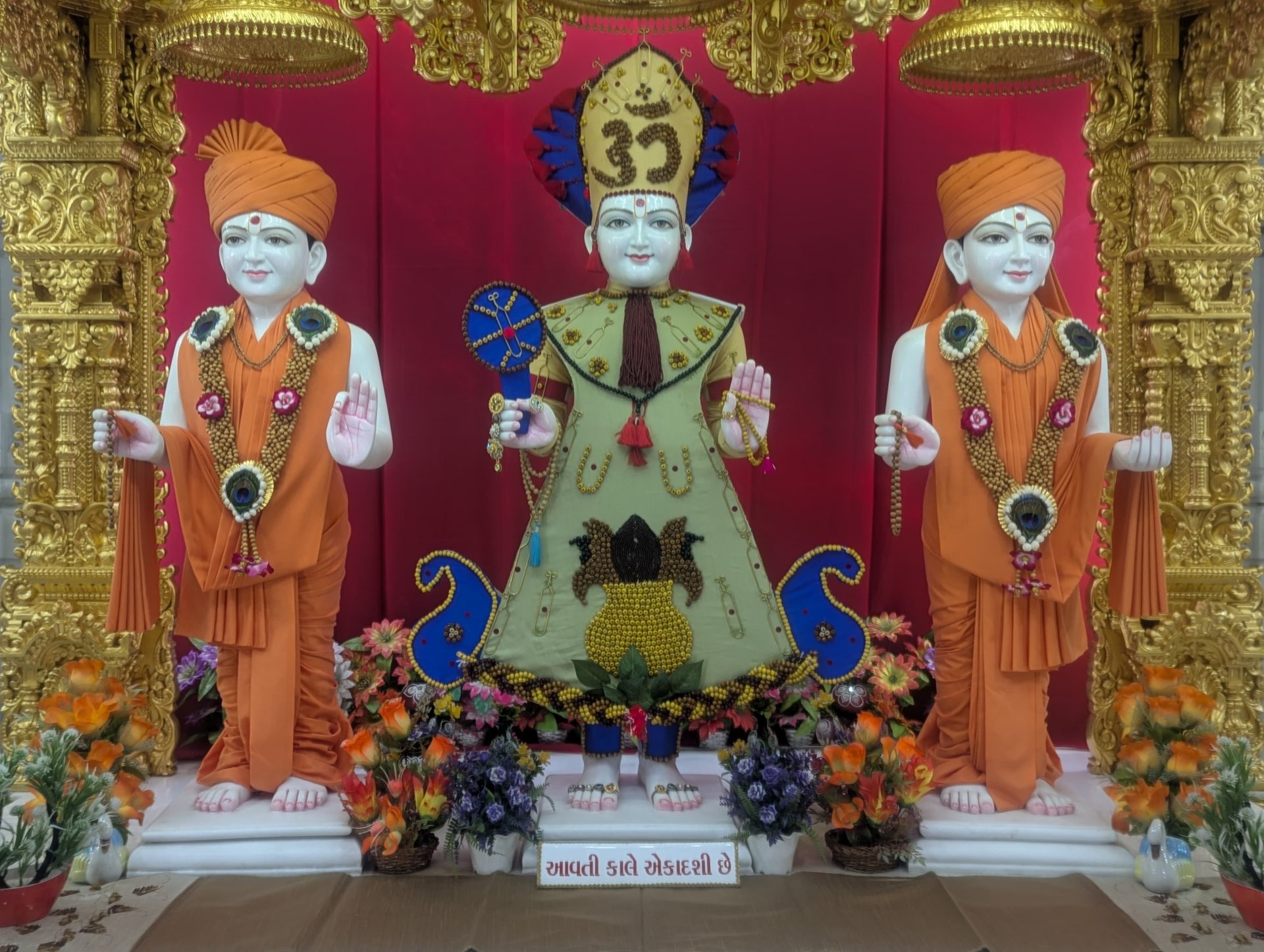 In Centre, Poorna Purushottam Shree Sahajanand Swami Maharaj, On Left Anadi Mul Akshar Murti Shree Gunatitanand Swami and On Right Anadi Mahamukta Shree Gopalanand Swami